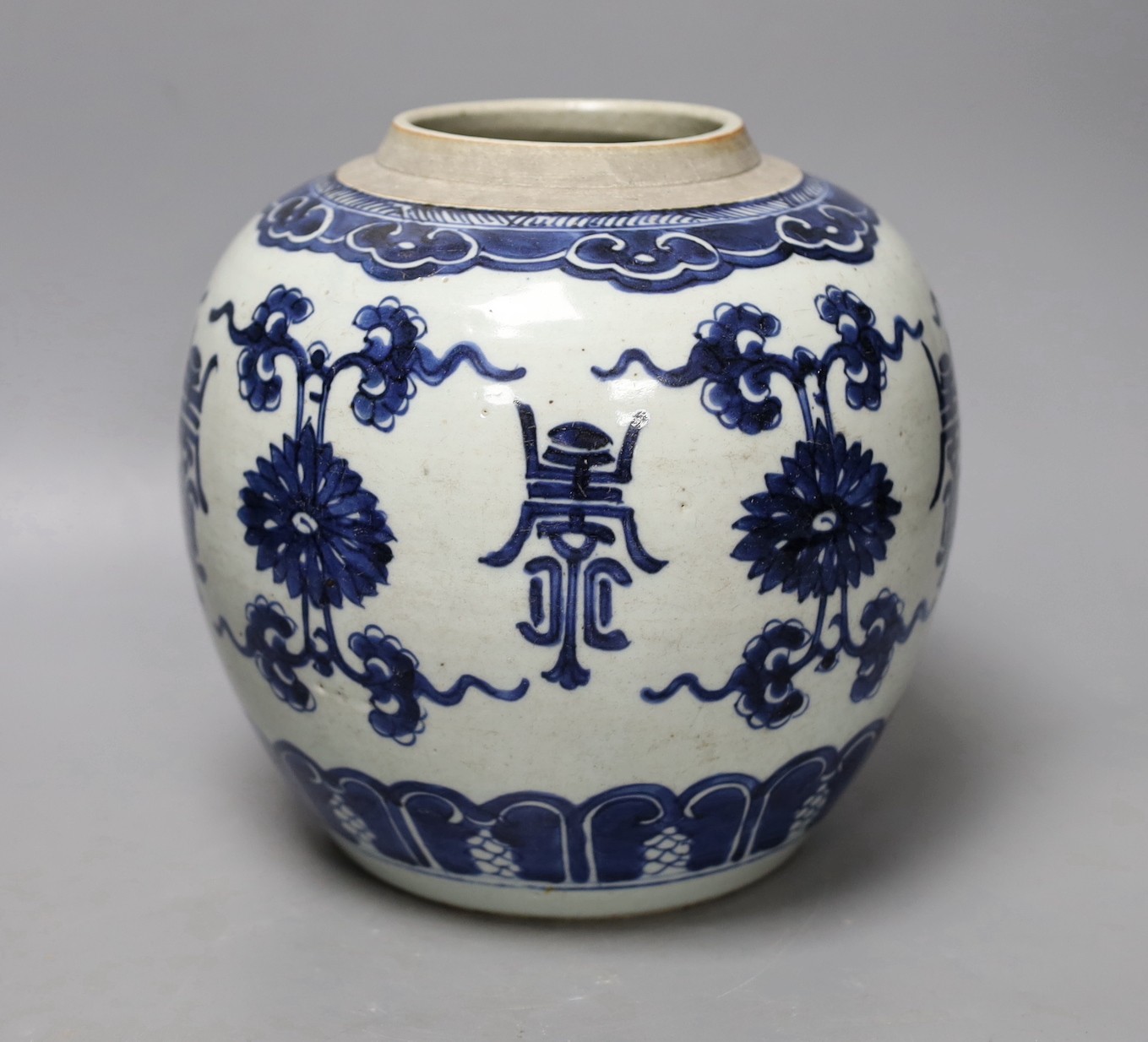 An 18th century Chinese blue and white jar, painted with ‘shou’, flowers and tendrils, 22cm high
